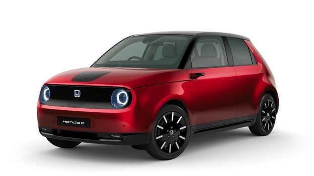 Modern steel metallic Honda e Side facing three quarter.