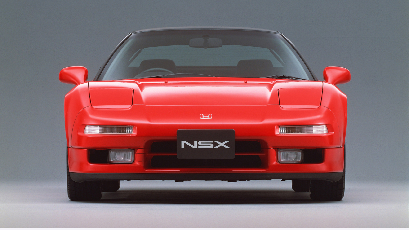 Vy framifrån av Honda NSX i en studio.