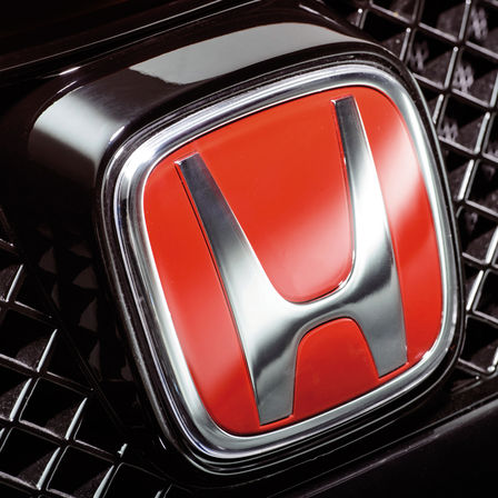 N&auml;rbild p&aring; Hondas r&ouml;da H-logotyp.