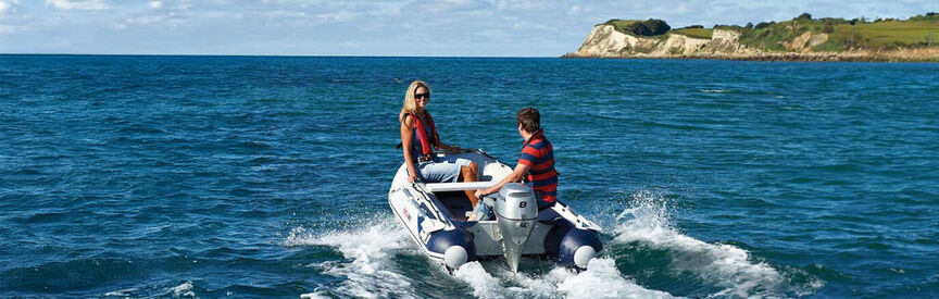 Man and woman drive a Honda boat